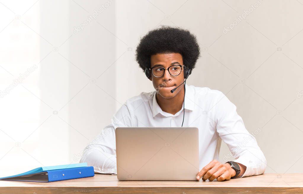 Young telemarketer black man thinking about an idea