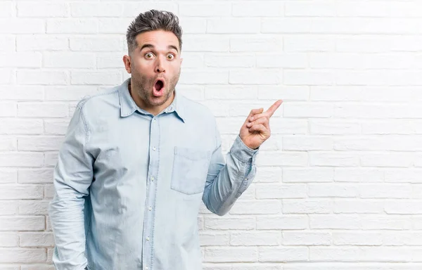 Young Handsome Man Bricks Wall Pointing Side — Stock Photo, Image