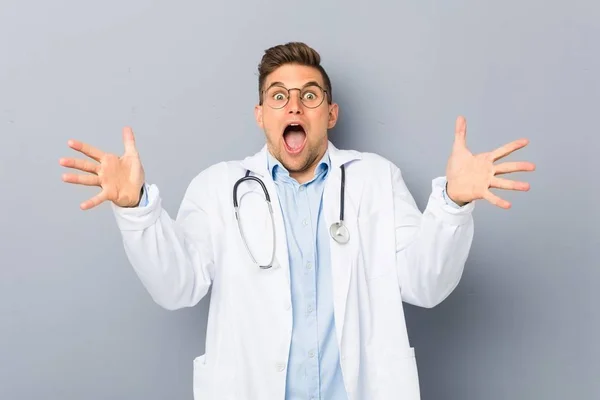 Young Blonde Doctor Man Celebrating Victory Success — Stock Photo, Image