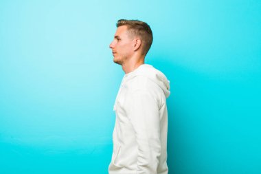 Kafkasyalı genç sporcu sola bakıyor, yandan poz veriyor.