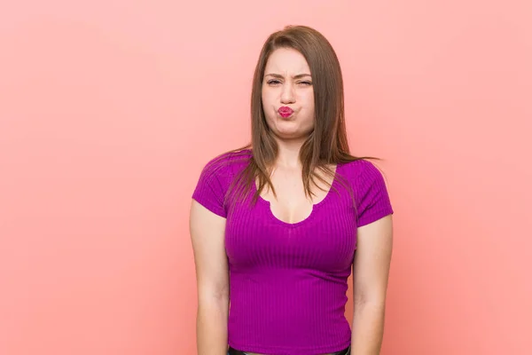 Young Hispanic Woman Pink Wall Blows Cheeks Has Tired Expression — Stock Photo, Image