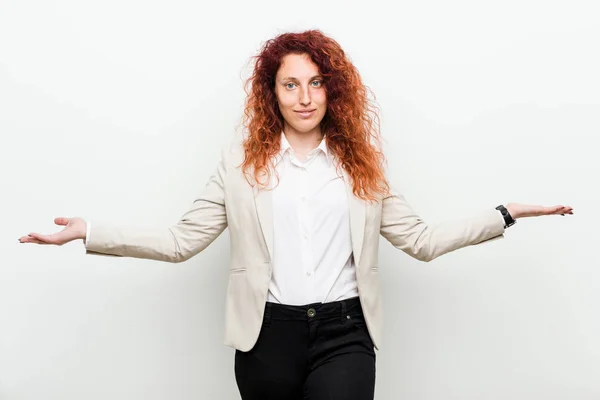 Young natural redhead business woman isolated against white background showing a welcome expression.