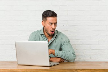 Genç filipinli adam onun dizüstü bilgisayar ile çalışan otururken o gördüğü bir şey nedeniyle şok oluyor.