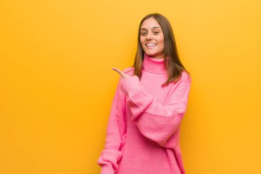 Genç modern kadın gülümseyerek ve yan işaret