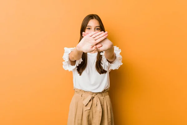 Young caucasian woman doing a denial gesture