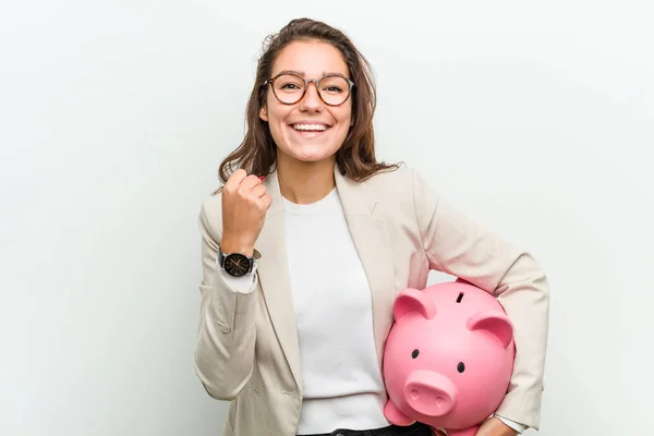 Young European Business Woman Holding Piggy Bank Cheering Carefree Excited — Stock Photo, Image