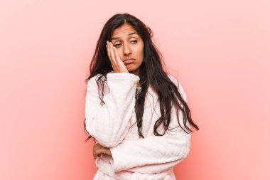 Young indian woman wearing pajama who is bored, fatigued and need a relax day.