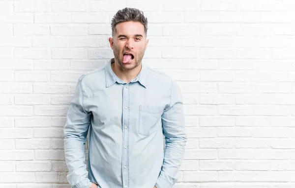 Young Handsome Man Bricks Wall Funny Friendly Sticking Out Tongue — Stock Photo, Image