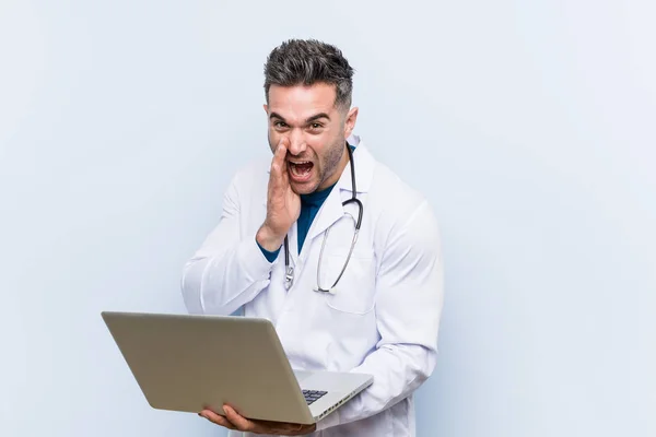 Caucasian Doctor Man Holding Laptop Shouting Excited Front — Stock Photo, Image