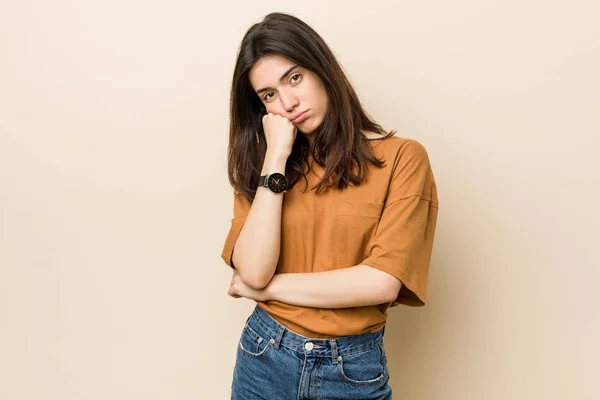 Young Brunette Woman Beige Background Who Feels Sad Pensive Looking — Stock Photo, Image