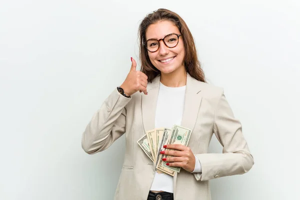 Young European Business Woman Holding Dollar Banknotes Smiling Raising Thumb — Stock Photo, Image