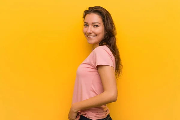 Young European Woman Isolated Yellow Background Looks Aside Smiling Cheerful — Stock Photo, Image