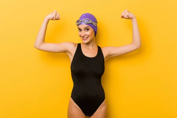年轻的游泳白种妇女显示力量手势与手臂 女性力量的象征 — 图库照片