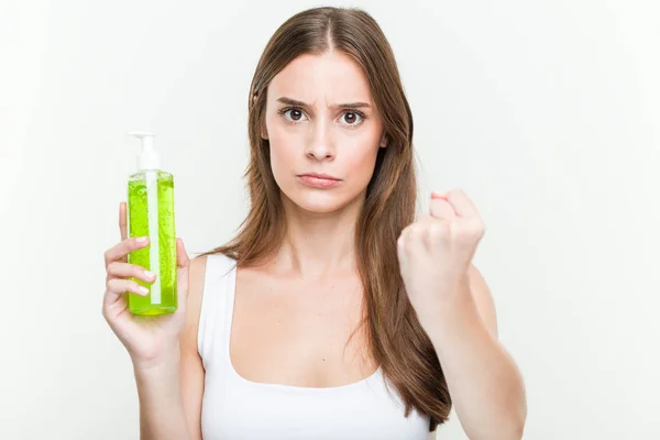 Young Caucasian Woman Holding Aloe Vera Bottle Showing Fist Camera — Stock Photo, Image