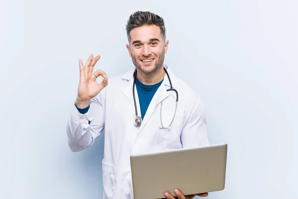 Caucasian Doctor Man Holding Laptop Cheerful Confident Showing Gesture — Stock Photo, Image