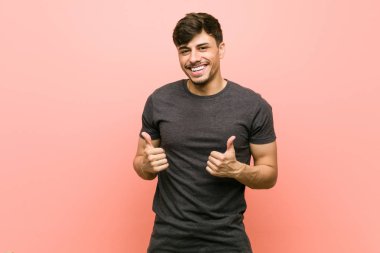 Young hispanic casual man raising both thumbs up, smiling and confident. clipart