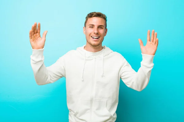 Young Caucasian Sport Man Receiving Pleasant Surprise Excited Raising Hands — Stock Photo, Image