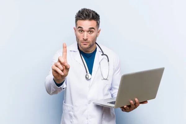 Caucasian Doctor Man Holding Laptop Showing Number One Finger — Stock Photo, Image
