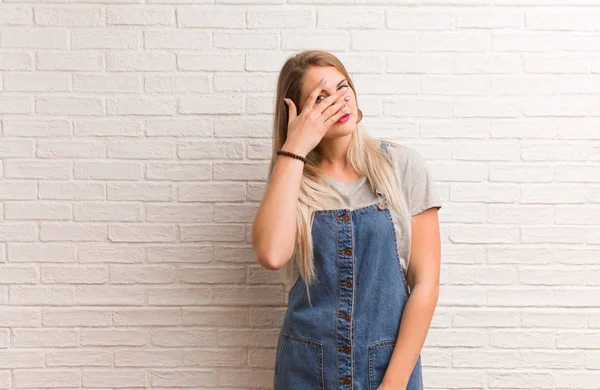 Young russian hipster woman embarrassed and laughing at the same time