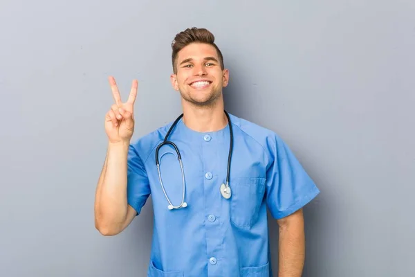 Young Nurse Man Showing Number Two Fingers — Stock Photo, Image