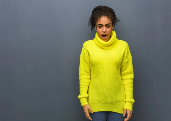 Young black woman screaming very angry and aggressive