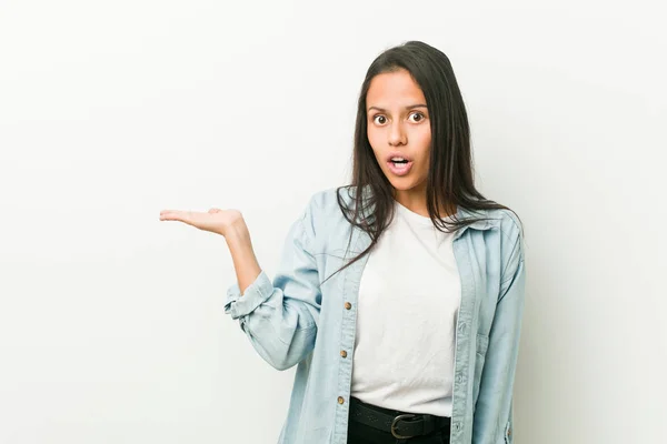 Young Hispanic Woman Impressed Holding Copy Space Palm — Stock Photo, Image