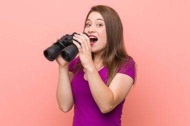 Dürbünle bakan beyaz genç kadın