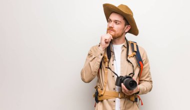 Genç kızıl saçlı kaşif adam şüphe ve karışık. Kamera tutma.