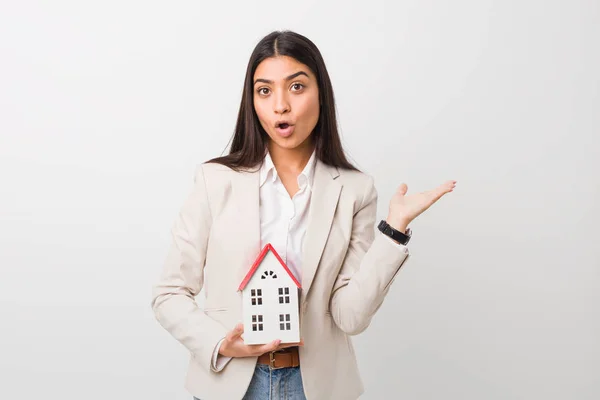 Young Arab Woman Holding House Icon Impressed Holding Copy Space — Stock Photo, Image