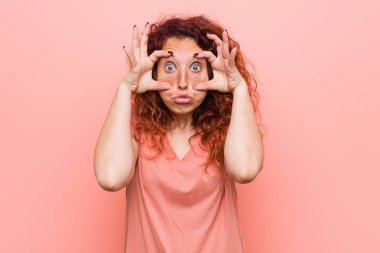 Genç doğal ve otantik kızıl saçlı kadın bir başarı fırsatı bulmak için gözleri açık tutmak.