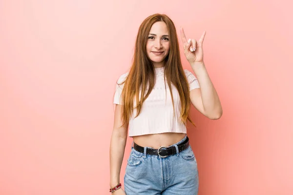 Young Redhead Ginger Woman Pink Wall Showing Horns Gesture Revolution — Stock Photo, Image