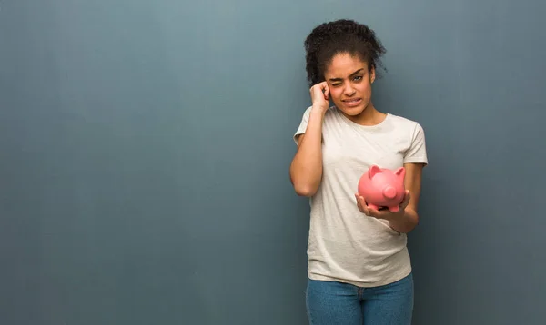 Young Black Woman Covering Ears Hands She Holding Piggy Bank — Stock Photo, Image