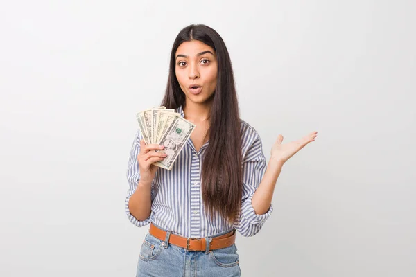 Young Arab Woman Holding Dollars Impressed Holding Copy Space Palm — Stock Photo, Image