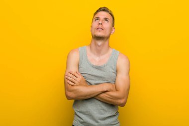 Young caucasian sport man tired of a repetitive task.