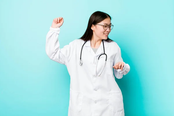 Young chinese doctor woman dancing and having fun.