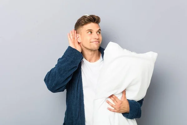 Young Man Wearing Pijama Holding Pillow Trying Listening Gossip — Stock Photo, Image
