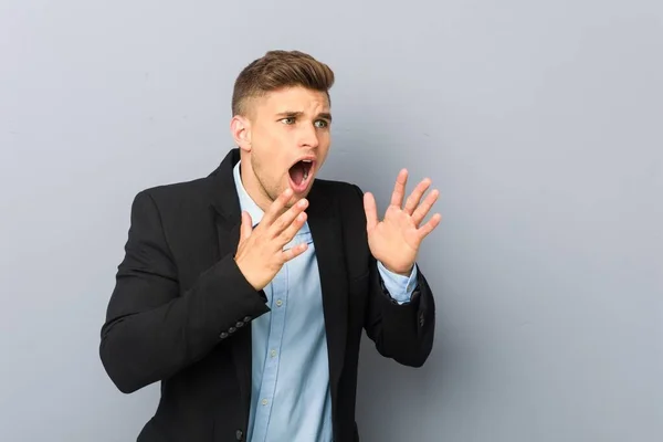 Young Handsome Caucasian Man Shouts Loud Keeps Eyes Opened Hands — Stock Photo, Image