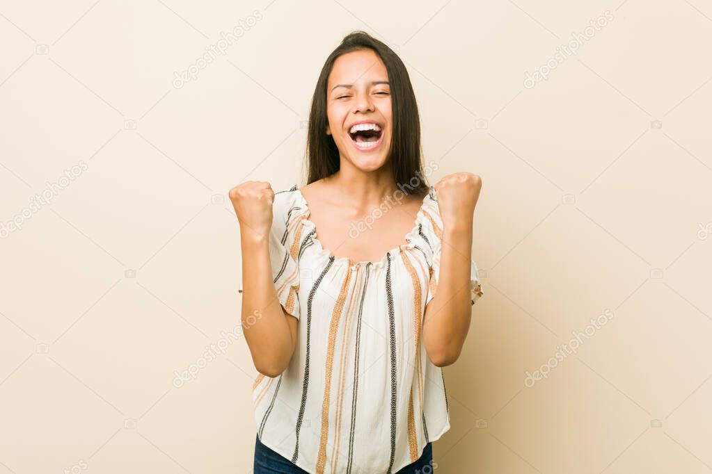 Young hispanic woman cheering carefree and excited. Victory concept.