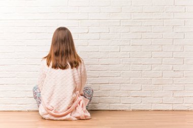 Arkasından pijama giyen genç kadın, geriye bakıyor