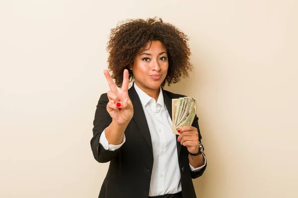 Young African American Woman Holding Dollars Showing Number Two Fingers — Stock Photo, Image