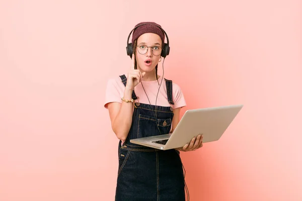 Young caucasian woman holding a laptop having some great idea, concept of creativity.