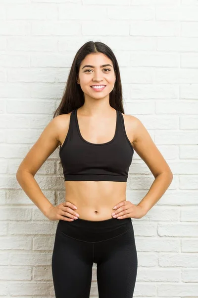 Arafed woman with a gym set of yoga pants and a sports bra, black
