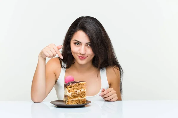 Young Hispanic Woman Eating Carrot Cake Stock Image