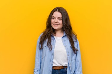 Genç kıvrımlı artı boyutu kadın mutlu, gülümseyen ve neşeli.