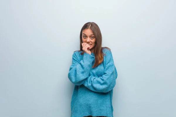 Jovem Mulher Bonita Vestindo Uma Camisola Azul Mordendo Unhas Nervoso — Fotografia de Stock