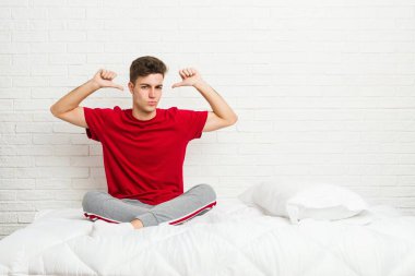 Yataktaki genç öğrenci gururlu ve kendinden emin, örnek olarak..