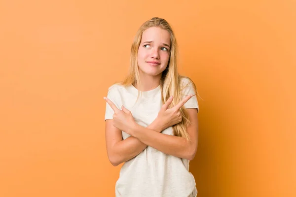 Cute Natural Teenager Woman Points Sideways Trying Choose Two Options — Stock Photo, Image