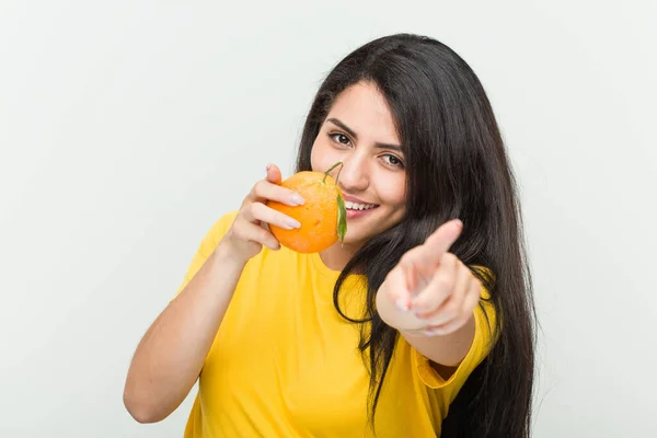 Young Hispanic Woman Holding Orange Cheerful Smiles Pointing Front Stock Picture