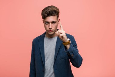 Genç iş adamı parmaklarıyla bir numara gösteriyor..