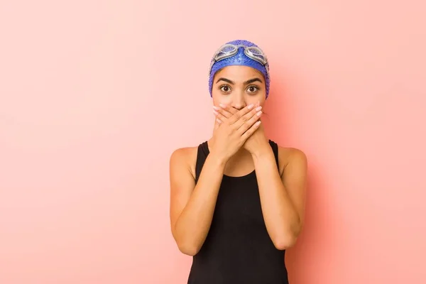 Young arab swimmer woman isolated shocked covering mouth with hands.